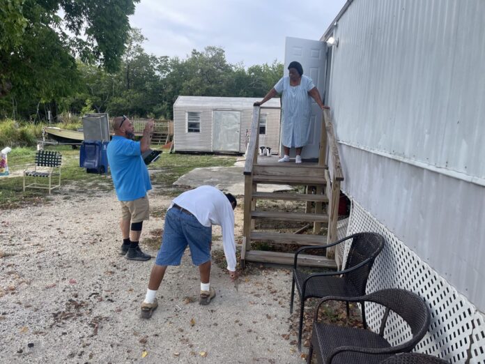 a couple of men standing next to a trailer