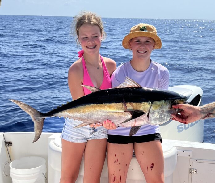 a couple of people on a boat with a fish
