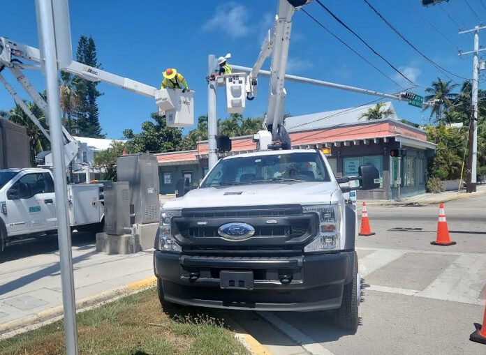 a white truck parked on the side of a road