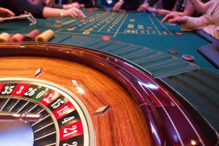 a casino table with a lot of people playing roule