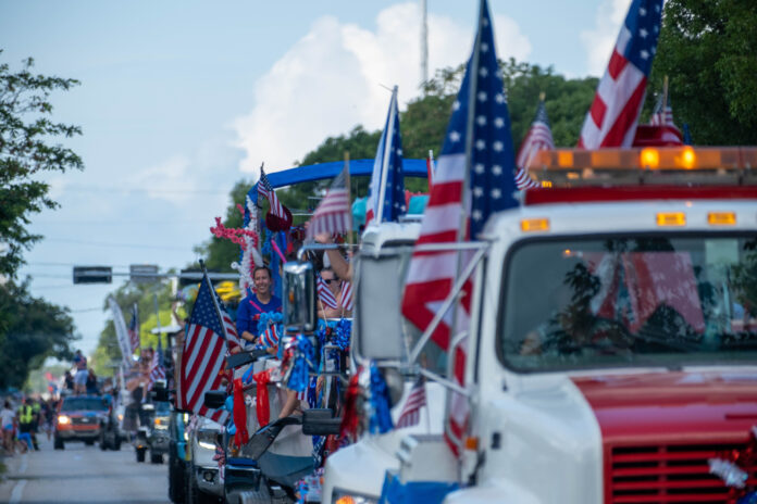 a parade with a parade float in the back of a truck
