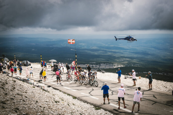 a group of people standing on top of a mountain
