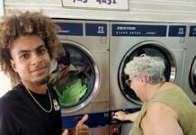 a man standing next to a woman in front of a washer