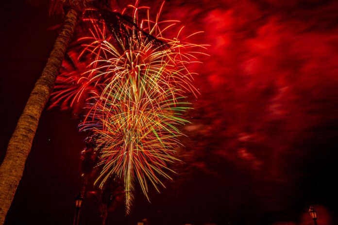 a fireworks display is lit up the night sky