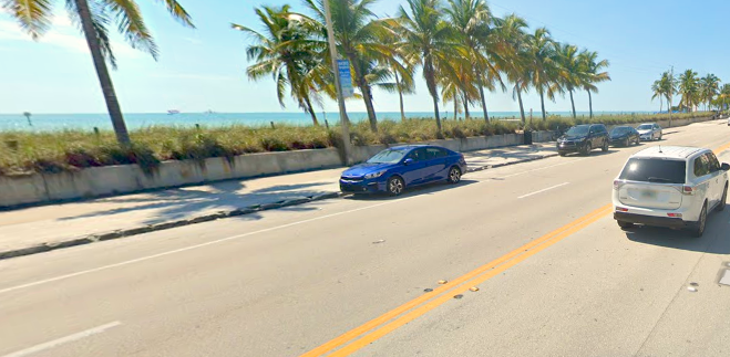 South Roosevelt a car driving down a street next to the ocean