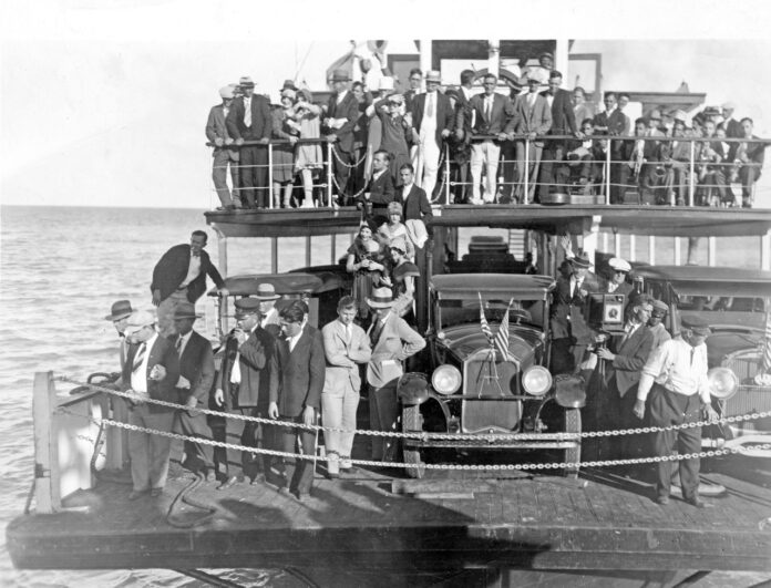 a large group of people standing on a boat