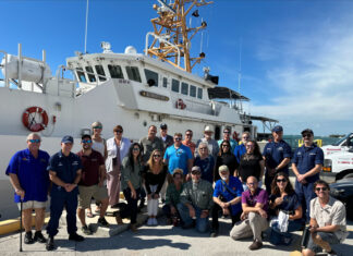 a group of people standing in front of a boat