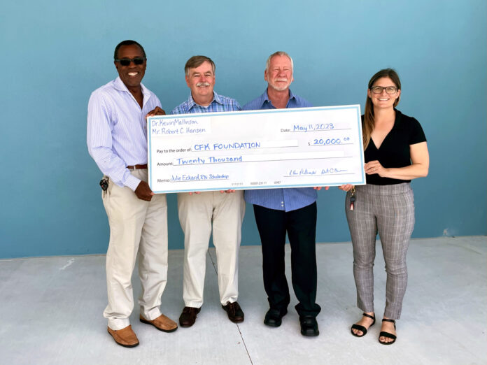 nursing endowment a group of people standing next to each other holding a large check