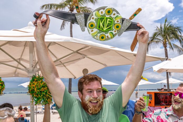 a man with a beard holding up a paddle