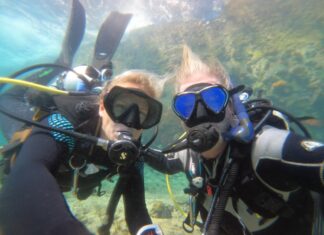 SCUBA DIVERS MAKE A FEEL-GOOD FIND AFTER BOAT CAPSIZES OFF DUCK KEY a couple of people that are in the water