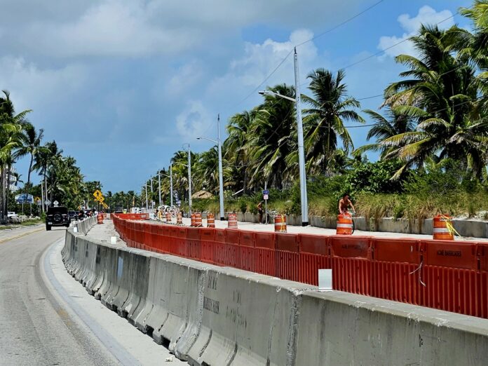 a road with a red barrier on the side of it