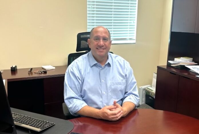 a man sitting at a desk in an office