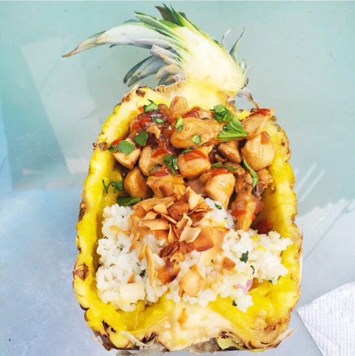 a pineapple filled with rice and nuts