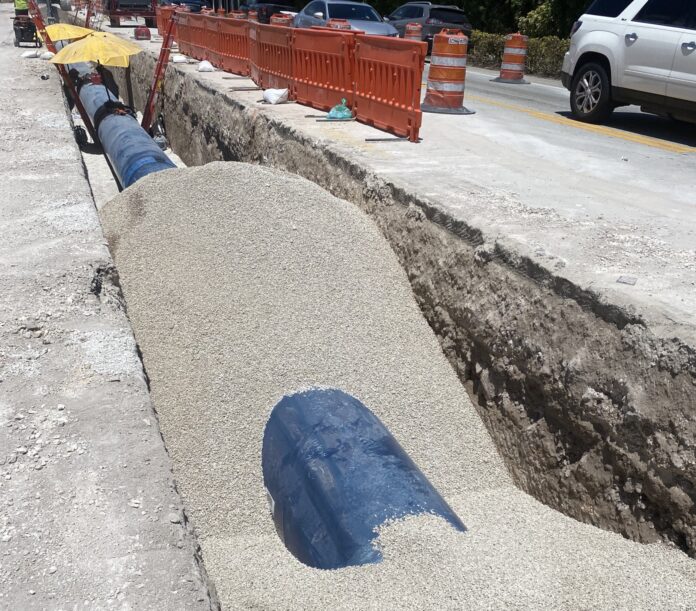 a large pipe laying on the side of a road