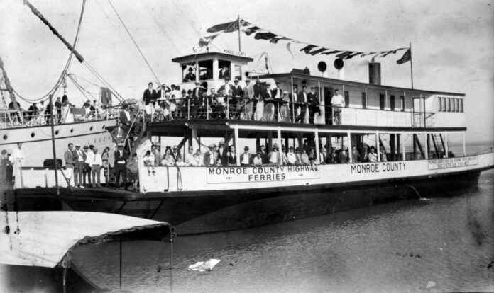 a black and white photo of a boat full of people