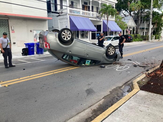 a car that is upside down in the street