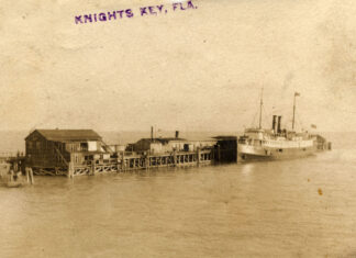an old photo of a boat docked at a pier