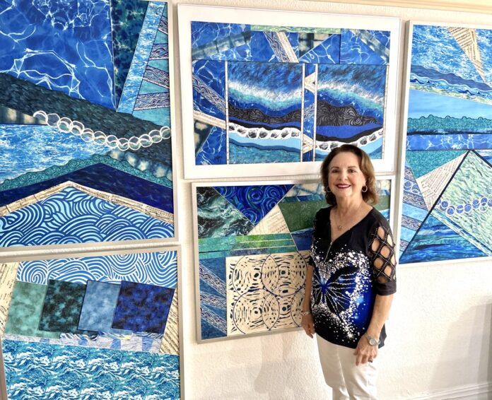 a woman standing next to a wall covered in art
