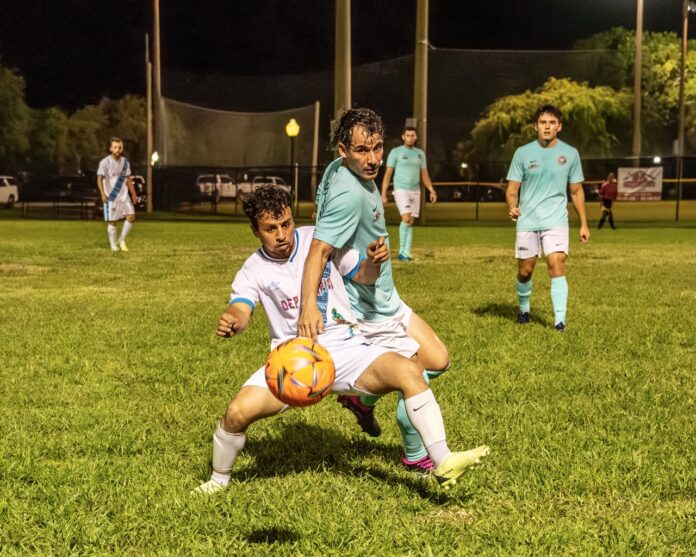 a group of young men playing a game of soccer