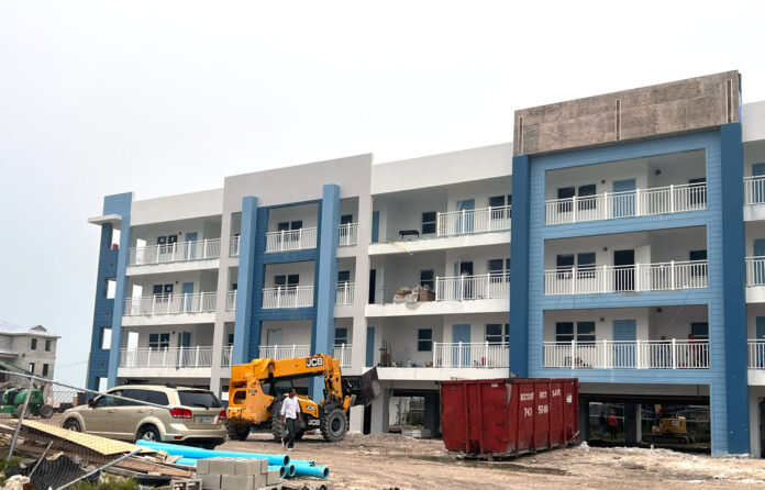 a large blue and white building with a crane in front of it