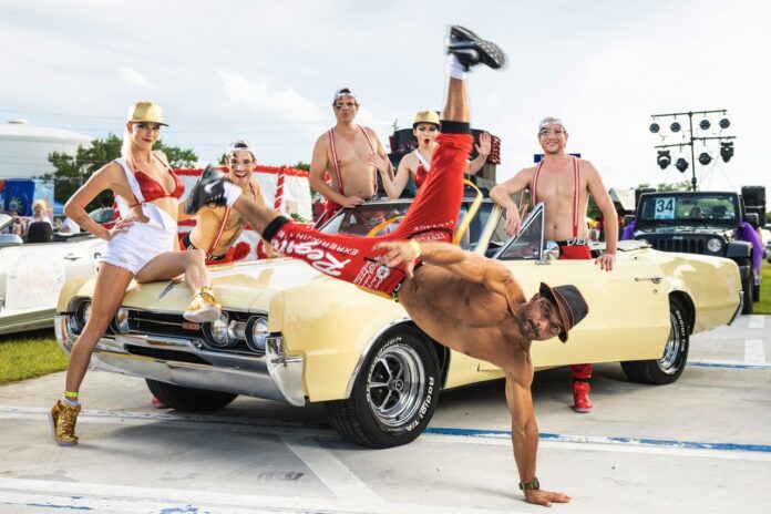 a man doing a handstand on the hood of a car