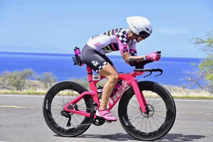 IMG_3400 a woman riding a pink bike down a road