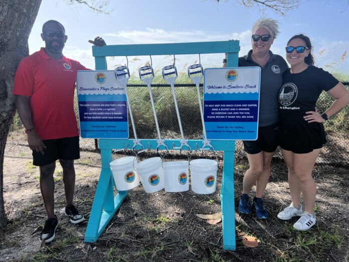 a couple of people standing next to a sign