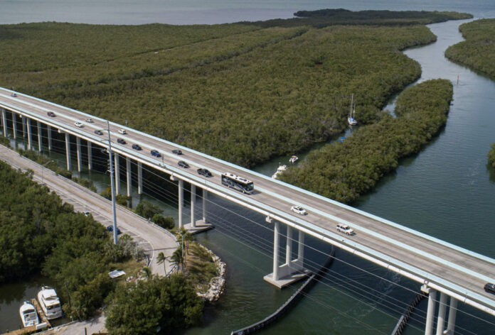 an aerial view of a bridge over a body of water