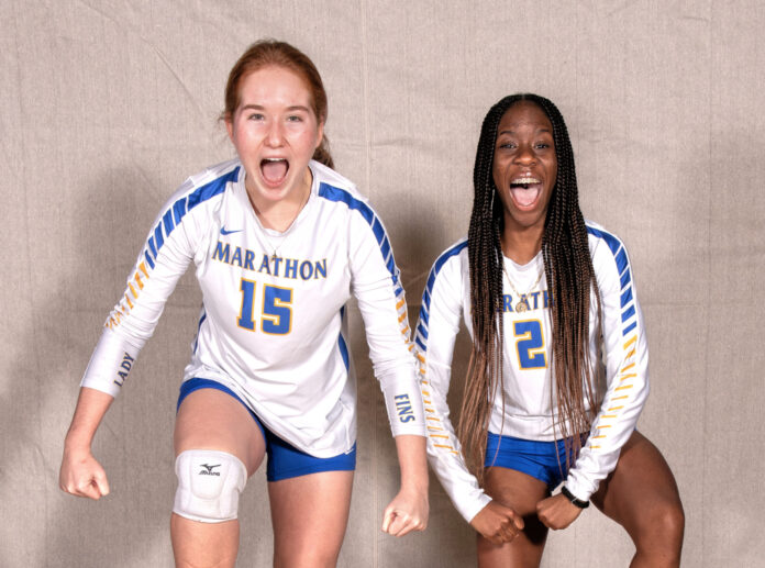 two female volleyball players posing for a picture