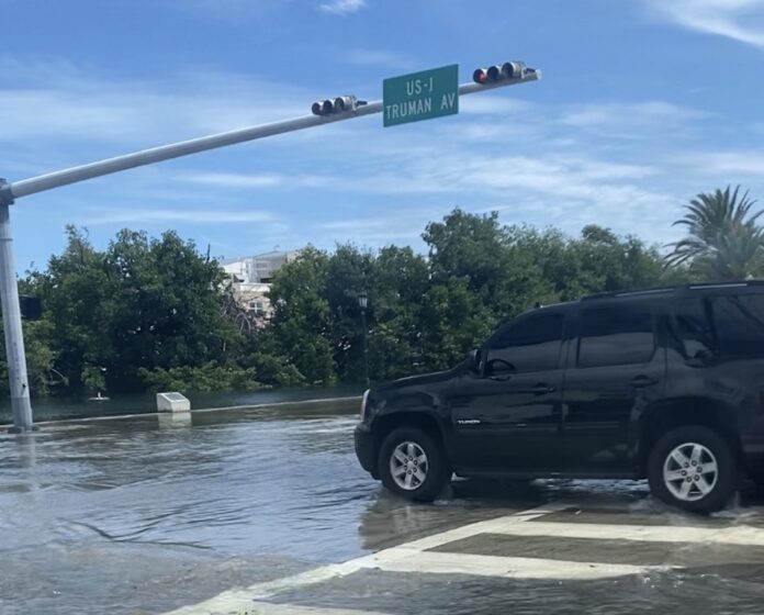 a car is driving through a flooded street