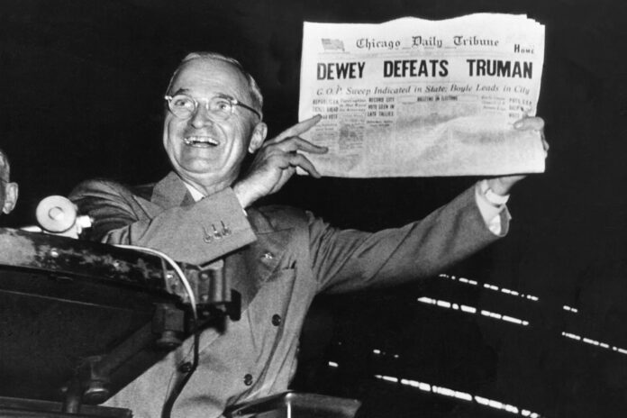 a man in a suit holding up a newspaper