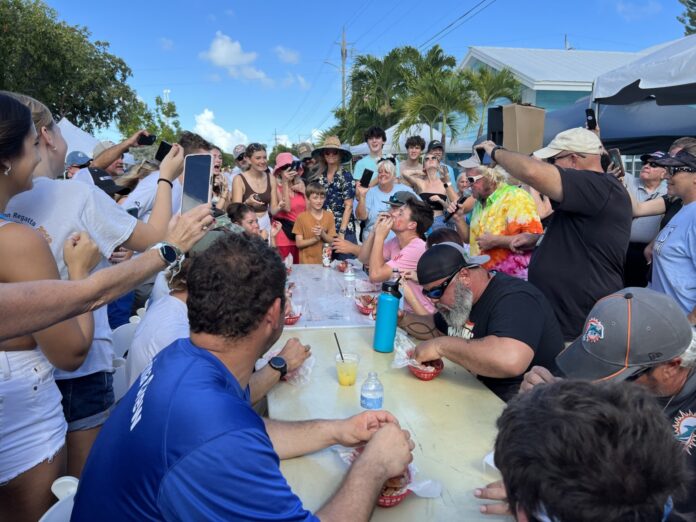 a group of people standing around a table