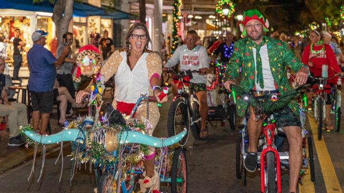 a group of people riding bikes down a street