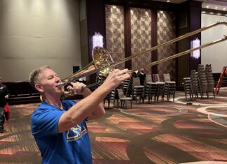 a man playing a trumpet in a large room