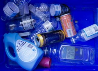 a blue container filled with lots of different types of bottles