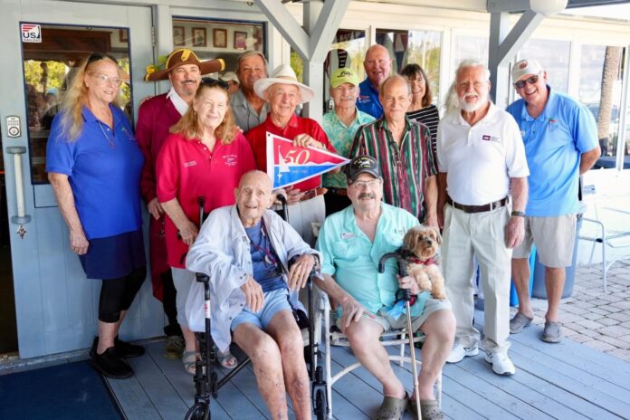 a group of people standing and sitting on a porch