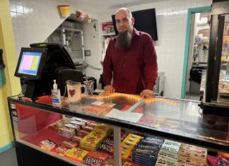 a man standing behind a counter in a store