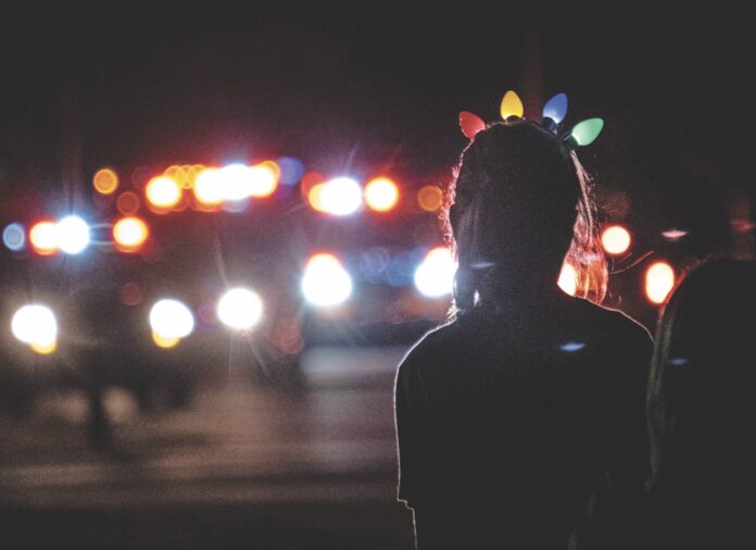 Isla Santa Parade File 2020 Large a person standing on a street at night