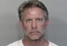 a mug shot of a man in a white shirt