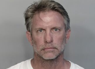 a mug shot of a man in a white shirt