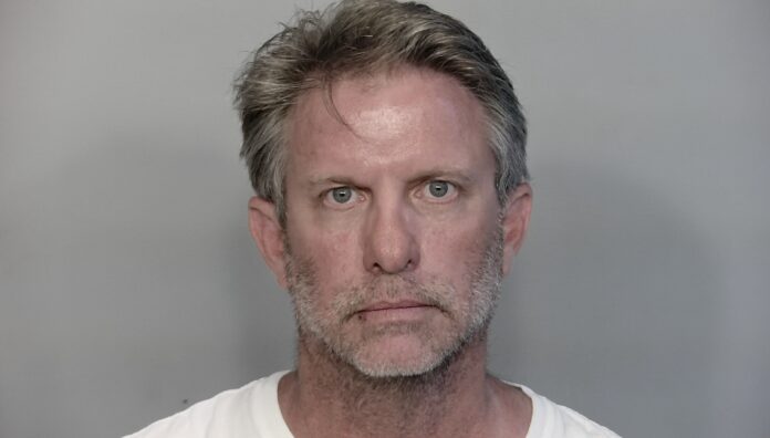 a mug shot of a man in a white shirt