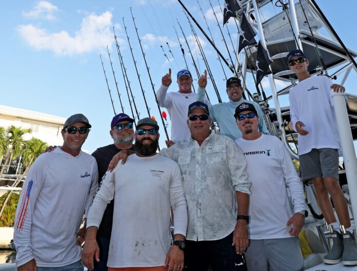 a group of men standing on top of a boat