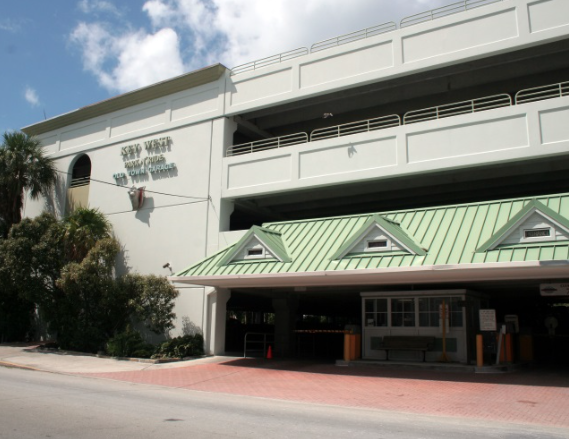 park n ride garage a large white building with a green roof