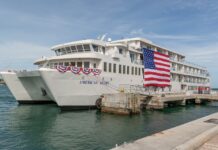 a large white boat docked at a pier