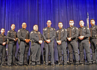 a group of police officers standing on a stage