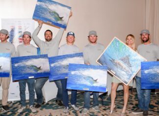 a group of people holding up paintings in front of them