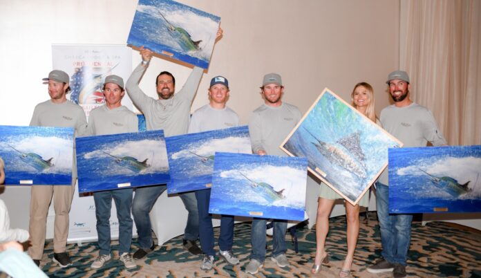 a group of people holding up paintings in front of them