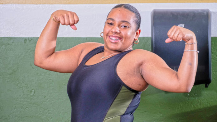 a woman flexing her muscles in a gym