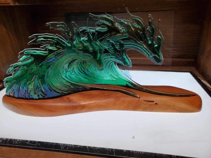 a sculpture of a wave in a wooden box