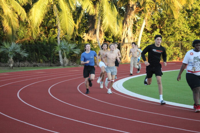 a group of people running on a track